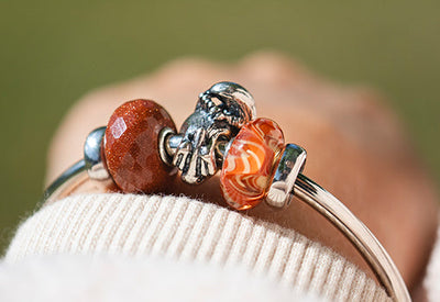Munga Thirri auf einer Armspange mit Orangenen Beads