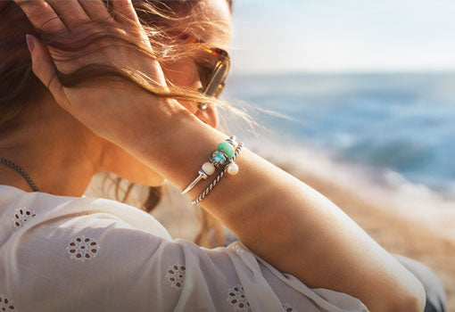 Model wearing Tides of Treasure summer collection by the beach
