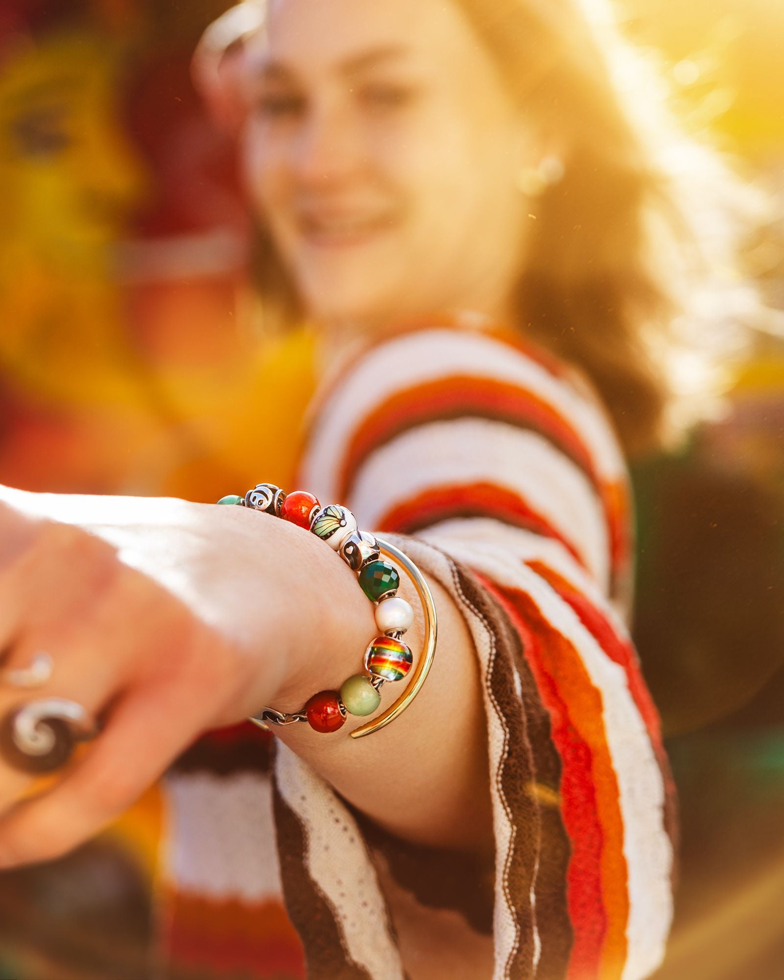 Frau, die ein sommerliches Trollbeads-Armband mit Beads trägt