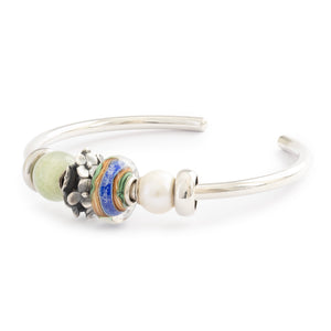 Silver bangle styling with Jusanji bead.