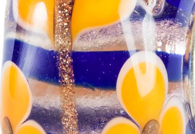 Close up of Trollbeads glass bead Harmony lilly with colors of blue yellow and glitter